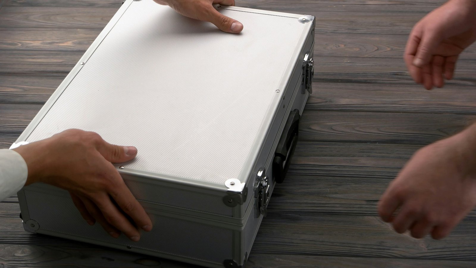 Close-up man with silver metal briefcase.